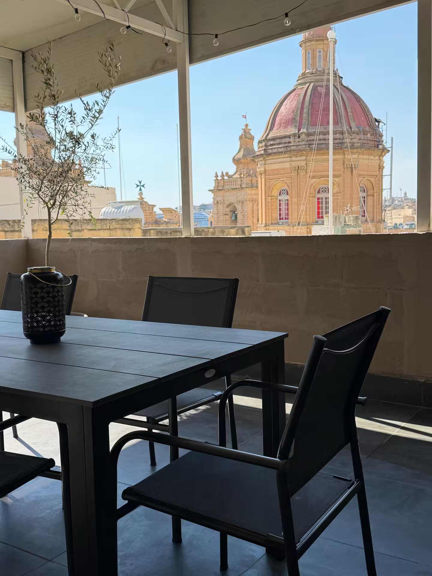 Cardinal Rooftop Townhouse — private rooftop with dining set and view of the Birgu Collegiate Church dome
